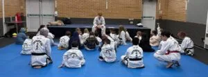 Little Dragons children in Hitchin sitting and listening to Taekwon-Do instructor